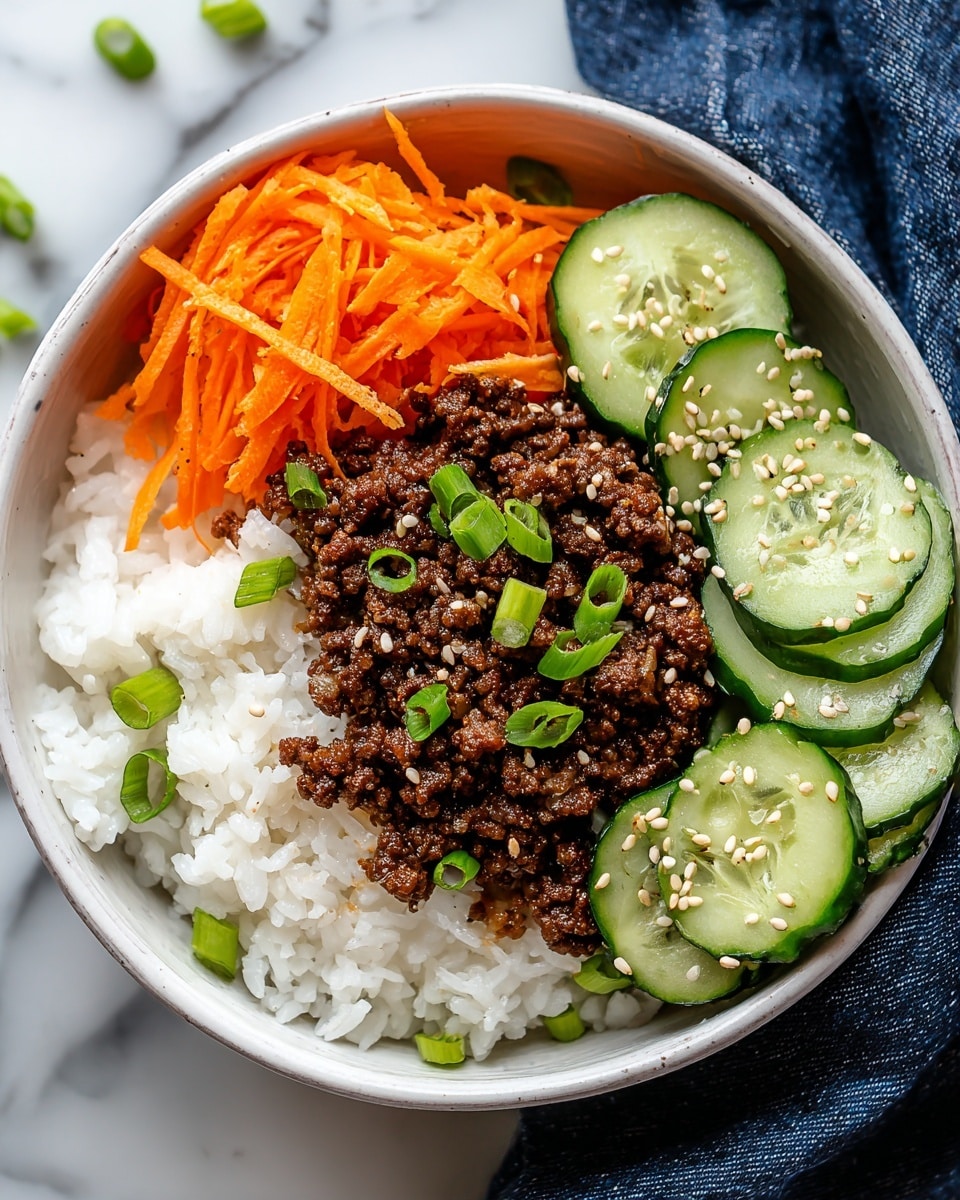 A white bowl filled with four distinct layers; the bottom layer is steamed white rice spreading across the base, topped on one side with a neat pile of shredded bright orange carrots sprinkled lightly with sesame seeds, next to thinly sliced cucumber rounds with dark green edges and pale green centers, also sprinkled with sesame seeds; in the center, a mound of dark brown cooked ground meat is placed, garnished with chopped green onions scattered over the meat and rice. The bowl is set on a white marbled surface next to a dark blue cloth. Photo taken with an iphone --ar 4:5 --v 7